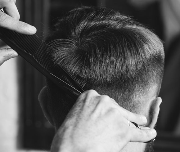Elevate your style with a sleek gents' haircut.